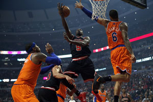 The Chicago Bulls Luol Deng loses control of ball while driving to the basket against the New York Knicks Tyson Chandler in the second quarter at the United Center in Chicago, Illinois, on Thursday, October 31, 2013. 
