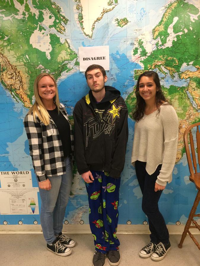Seniors Shannon Freund, Zach Ermey-Kline, and Arienne Weil pose for a picture in the Rhetorical Analysis of Media class.