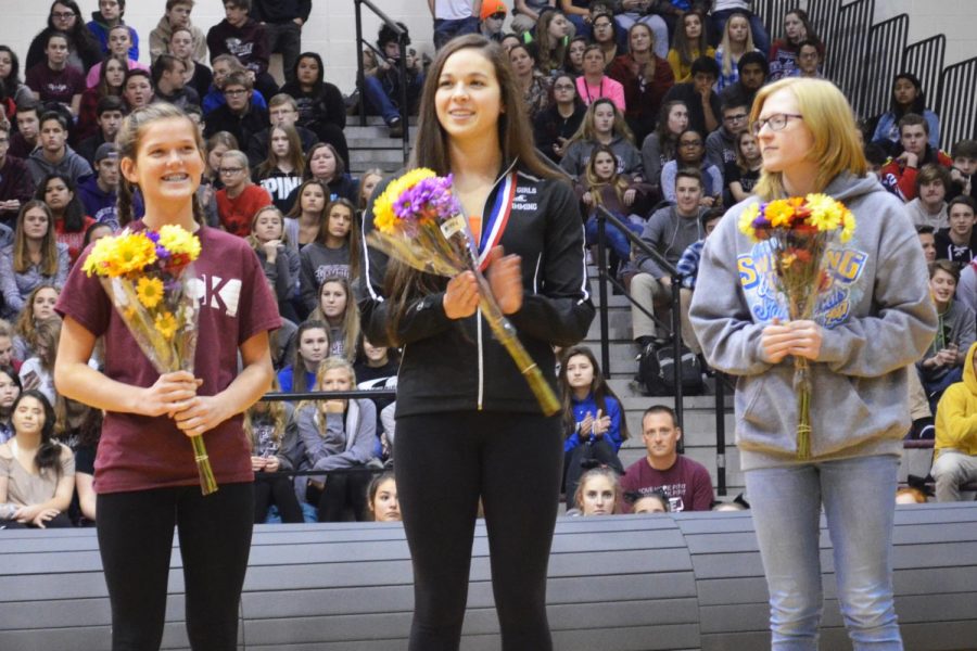Chelsea Gale, Valerie Tarazi, and Makayla Nietzel stand in recognition for their accomplishments in Cross Country and Swimming at the Fall Honors Assembly on December 1, 2017.