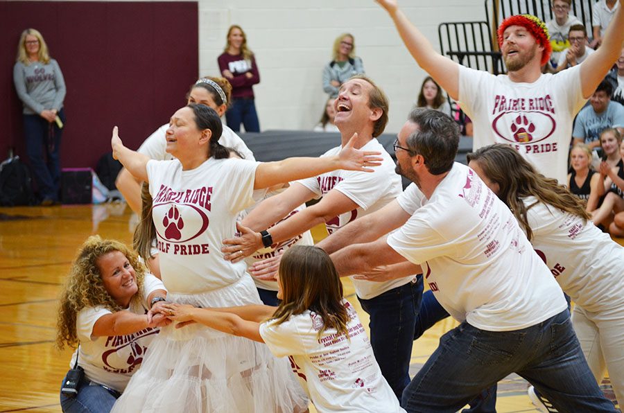 Prairie Ridge High School Teachers pose at the end of their dance feature during the fall 2018 Homecoming Assembly. The teacher dance is always a crowd favorite.