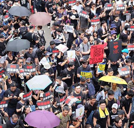 Protestors in Hong Kong on June 16, 2019, use umbrellas to hide their faces from the facial recognition used by the Chinese government.