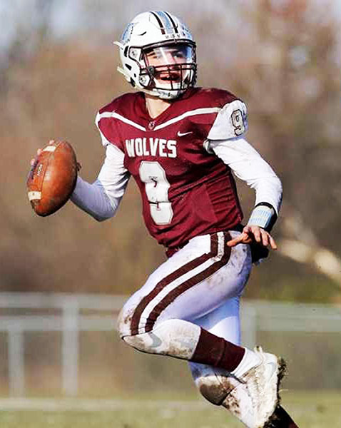 Connor Lydon, Prairie Ridge quarterback, leans back before a pass during the 2019 season.