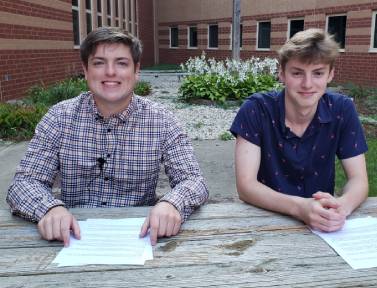 Seniors Grant Preves and Dimitri Vuyadinov smile for a picture after recording the first news team broadcast of the 2021-2022 school year.