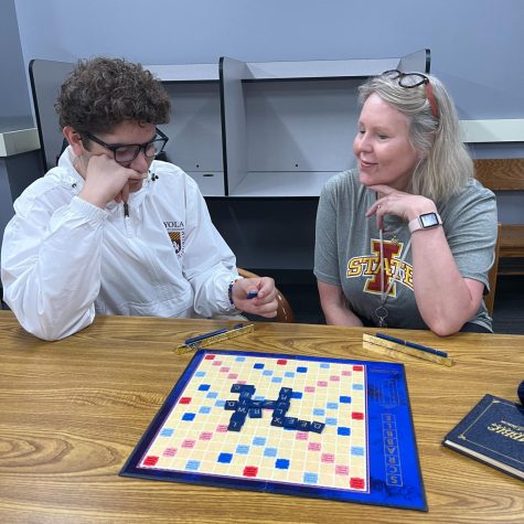 Senior David Llanes and Mrs. Hartnett enjoy a game of Scrabble in the library.